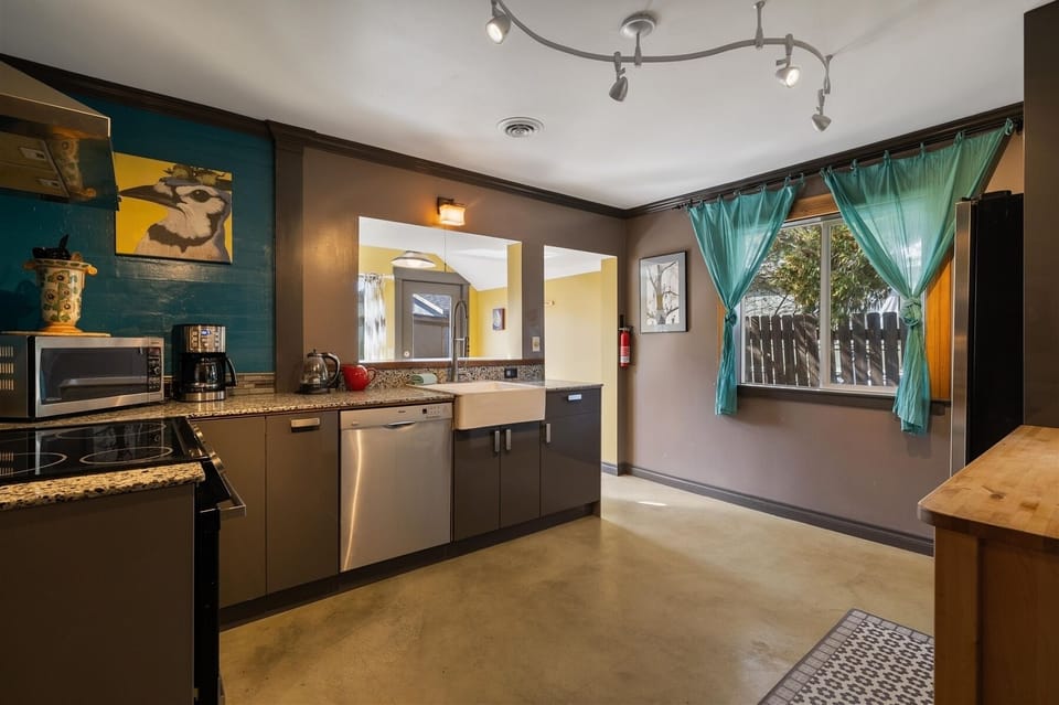 Fully equipped kitchen with granite slab counters, stainless steel appliances