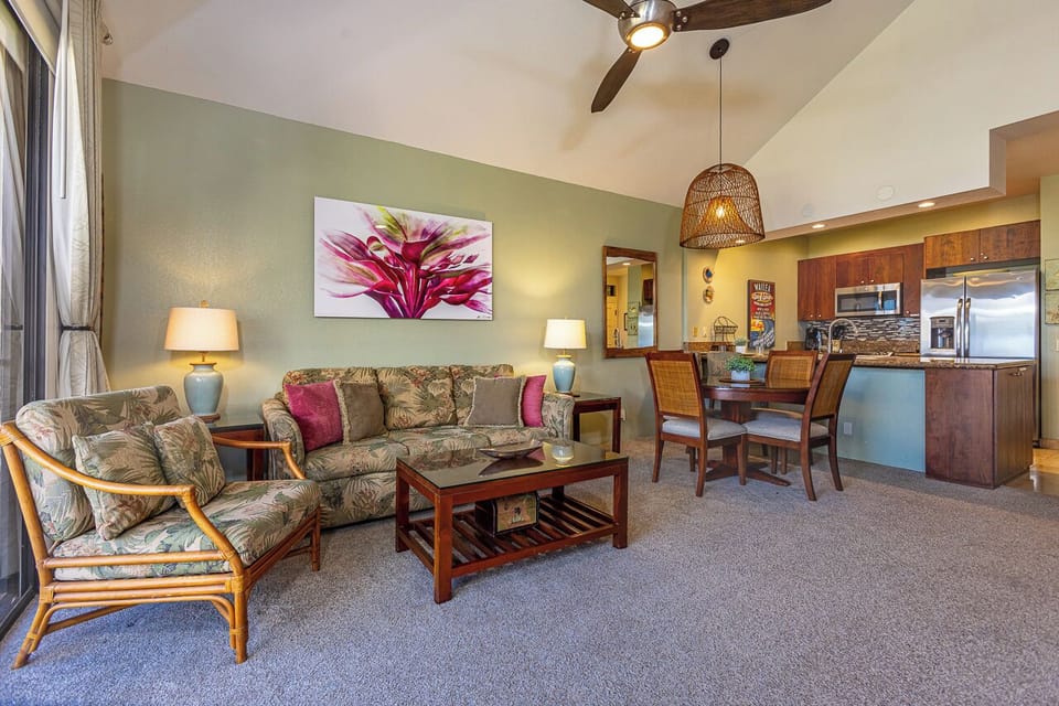 Step into your bright tropical haven, where island-style comfort meets modern convenience. Relax in the airy living room with vaulted ceilings, then gather around the dining table or prepare meals in your fully equipped kitchen.