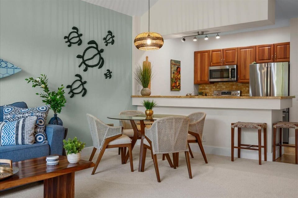 Your bright open-concept living space blends relaxation and function, with coastal-inspired décor, a fully equipped kitchen, and a cozy dining area perfect for enjoying meals together.