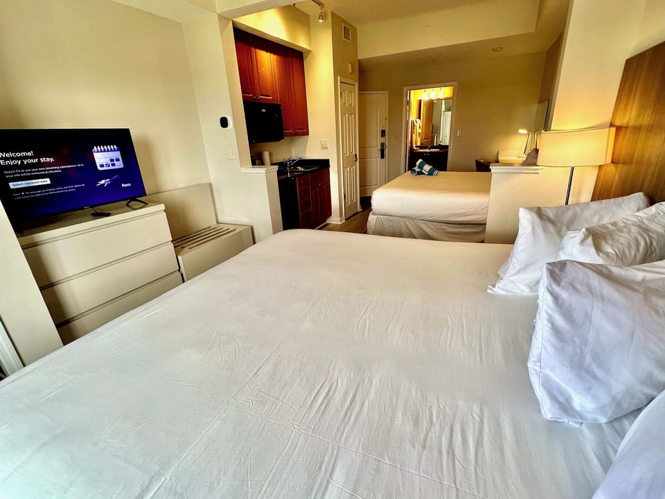 Premium Hotel room, two king beds, kitchenette, Wi-Fi, desk, Full Tile Bath