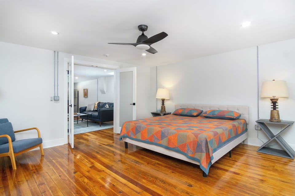 Spacious primary bedroom with king-size bed.