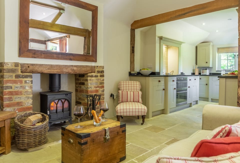 Ground floor: Open plan living area with wood burner and original oak beams