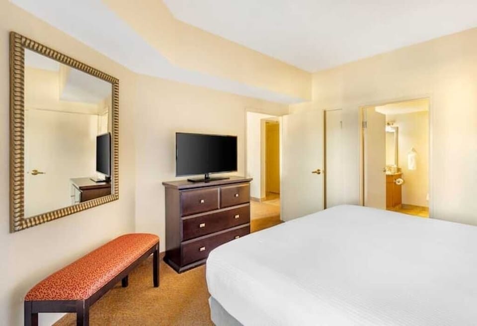 Settle in comfortably with in-room TV and ample dresser storage.