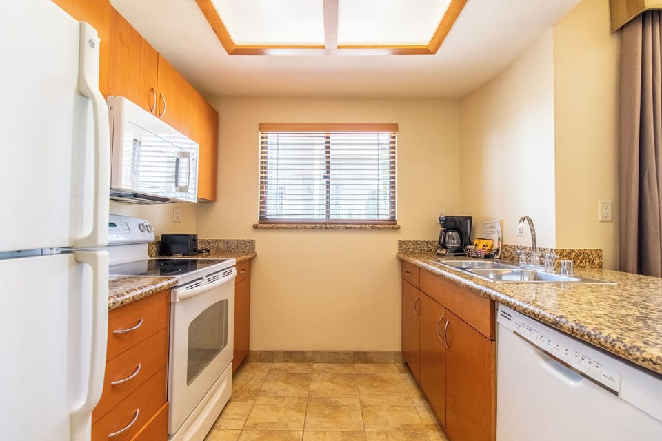 Cook with ease on granite counters in a bright kitchen.