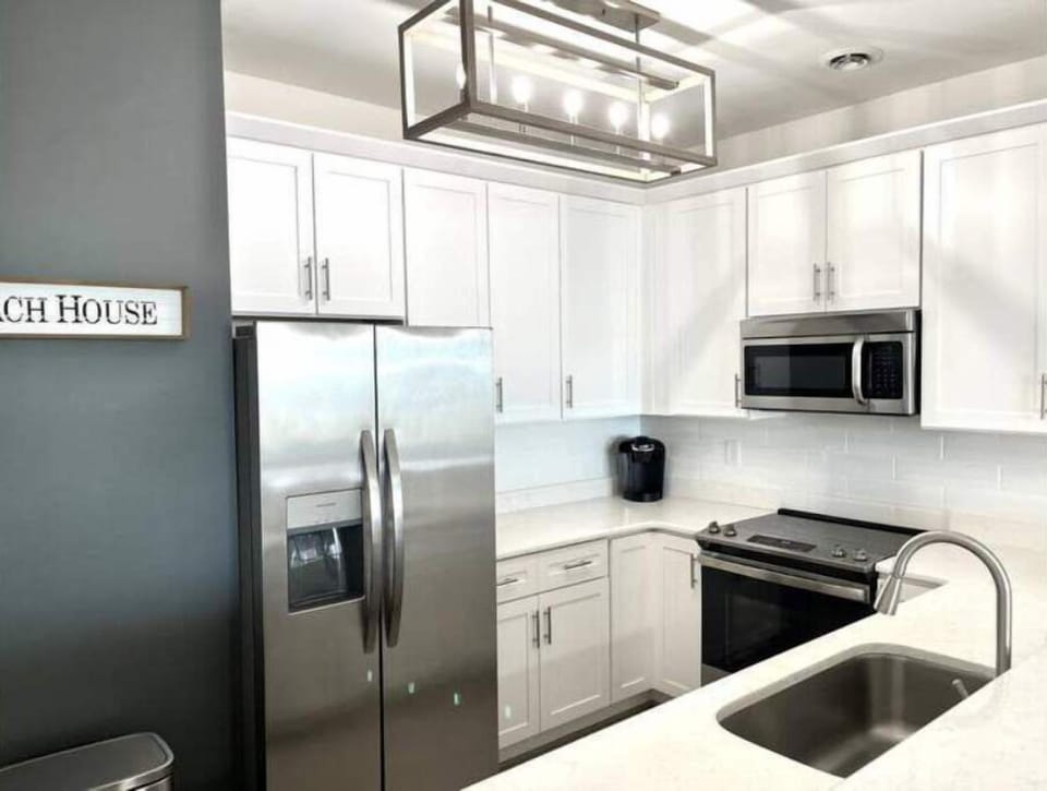 Kitchen - new lighting, new SS appliances and white subway tile backsplash.