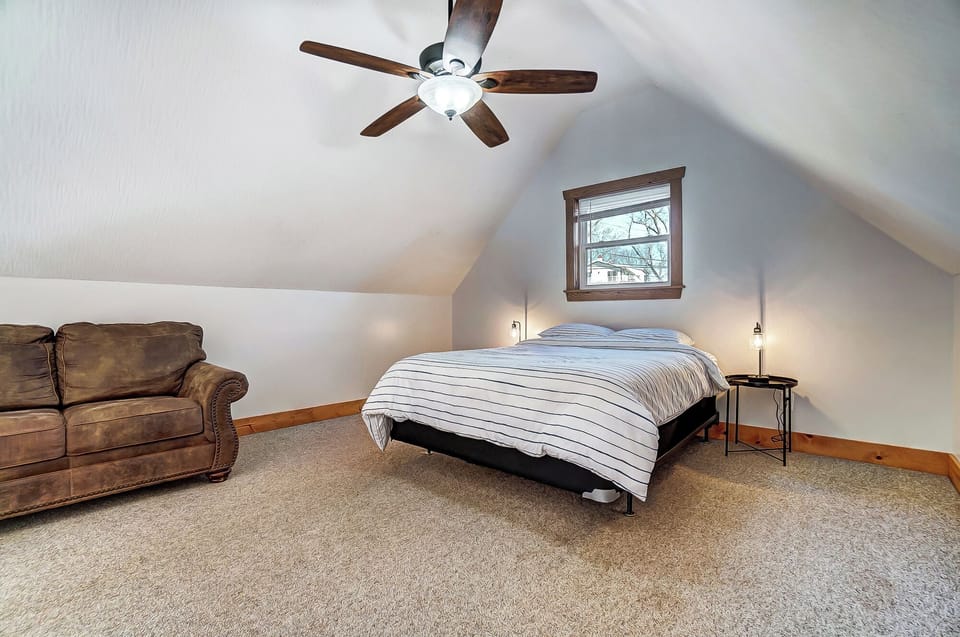 Bedroom 2 located in the upstairs open loft space features a queen bed and couch