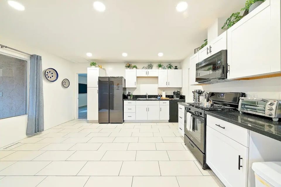 Large open kitchen equipped w/ stove, oven, microwave, toaster oven, coffee pot