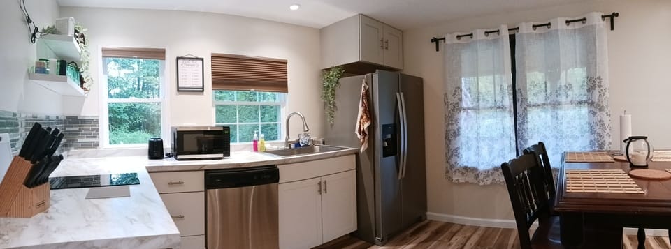 Kitchen. Stove top with 2 burners, toaster, microwave dishwasher, fridge.