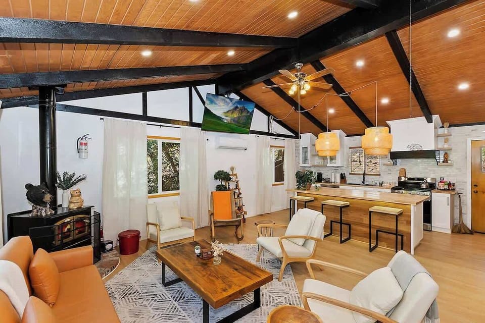 Living room and kitchen with island. Decorative fireplace only