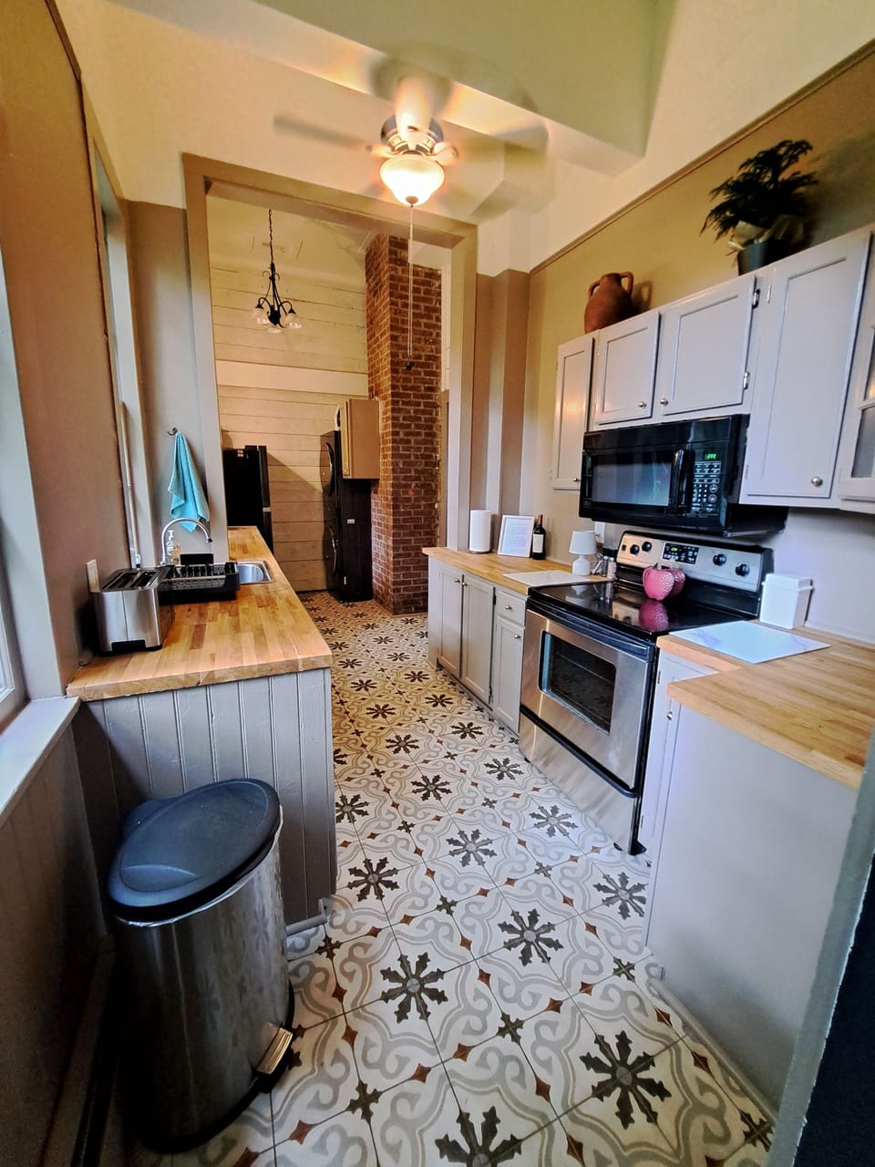 Washer/dryer across from refrigerator. Propane grill on outdoor deck