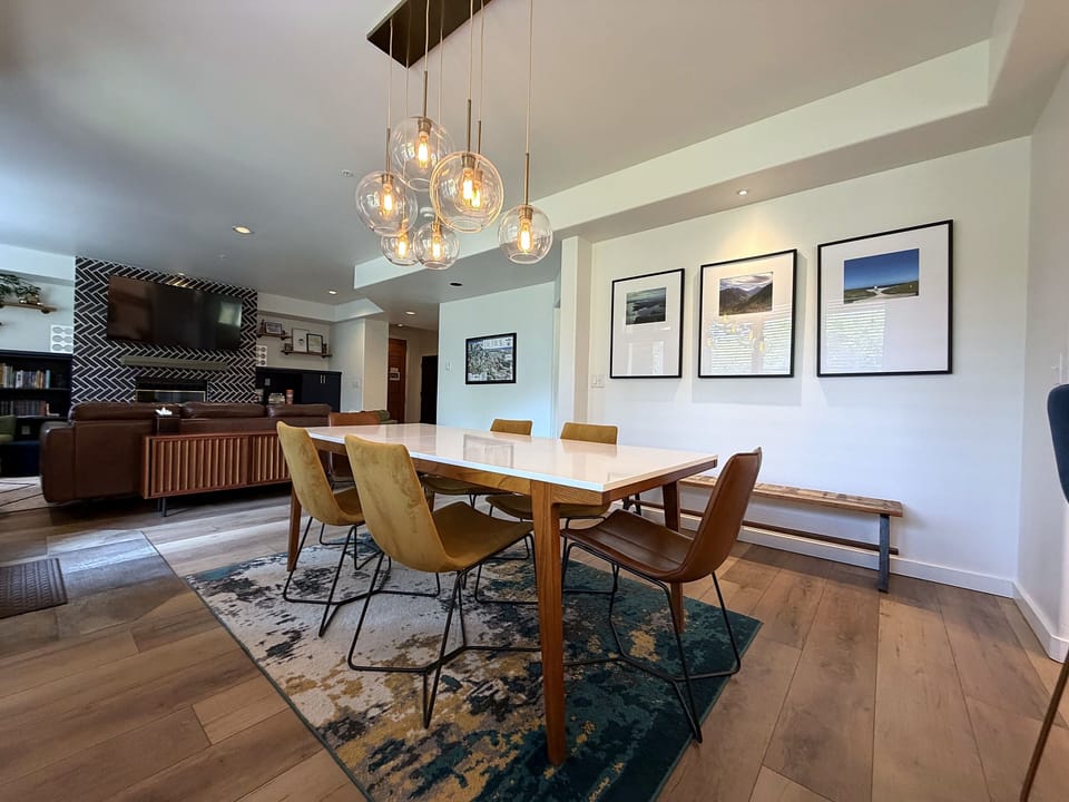 The dining table has room for 8, with 3 additional seats at the bar