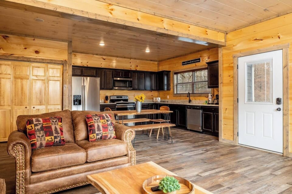Open living, dining, and kitchen area ideal for socializing and enjoying the stocked kitchen!