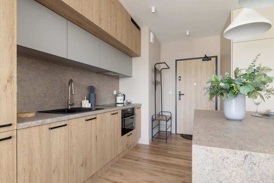 A closer look at the kitchen showing built-in appliances, sleek wood finishes, and thoughtful design.
