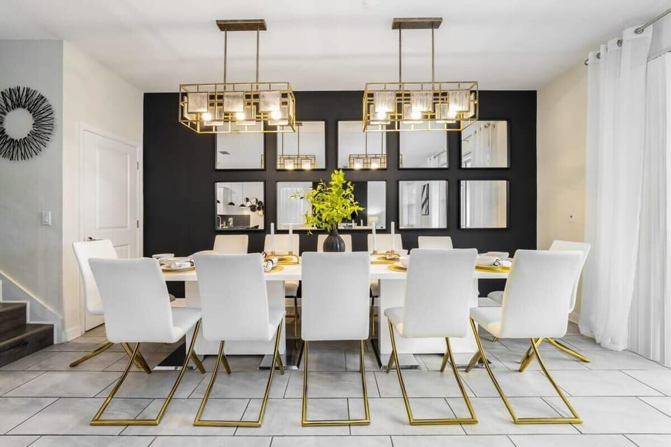 Luxurious dining room with chic gold accents and modern chandeliers, perfect for hosting memorable gatherings in style.