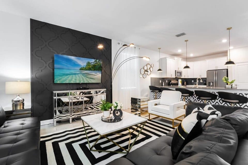 Stylish living area with sleek design and open kitchen, ideal for entertaining and relaxing in a luxurious setting.
