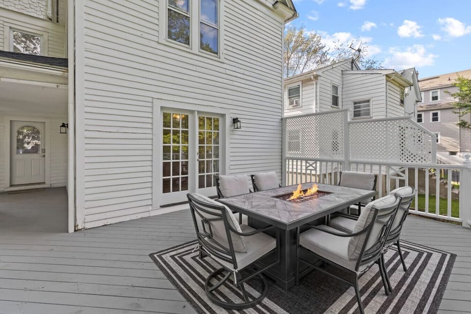 Spacious deck with seating for six around a cozy fire pit, plus a gas grill for easy outdoor cooking—perfect for relaxing evenings and entertaining.