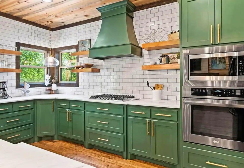 Cook in comfort with our expansive counters and stylish green cabinetry