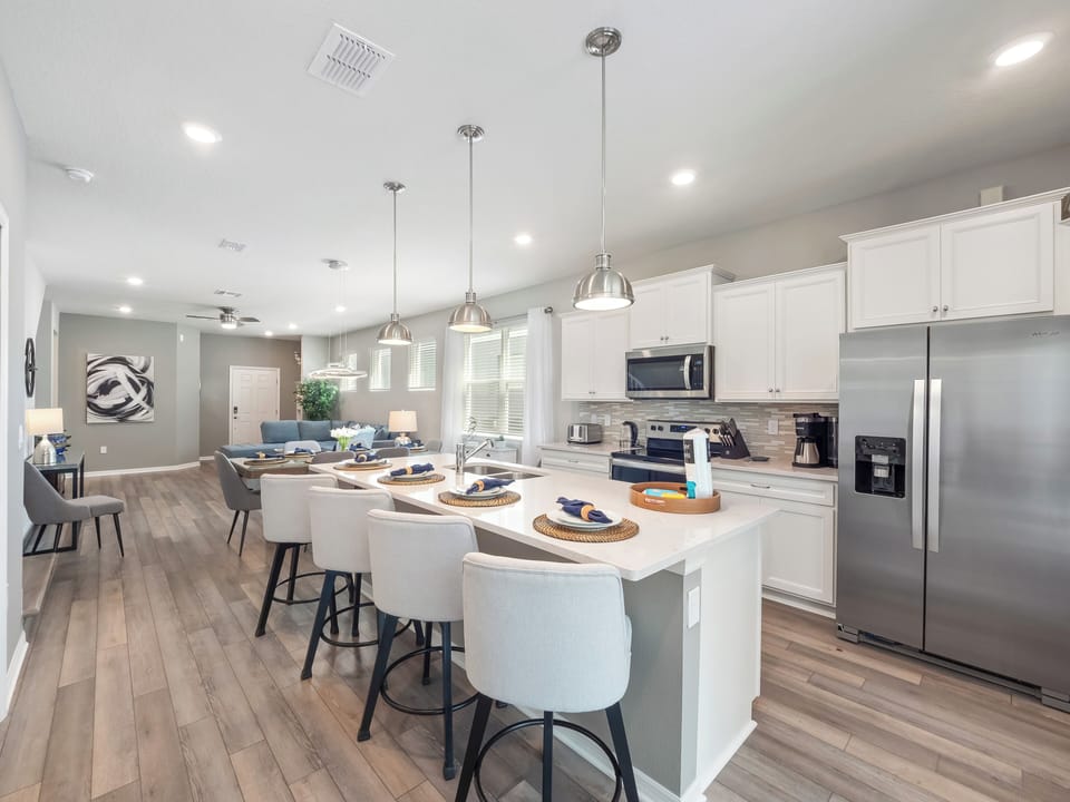 Spacious Full Size Kitchen Area with Kitchen Essentials and Barstool Seating