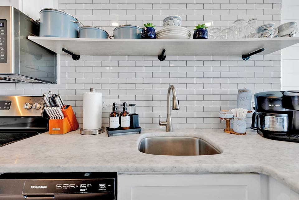 Coastal Kitchen Oasis: Blue Cookware, Granite, Seagulls
