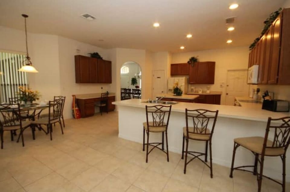 Kitchen Area that Seats 3 People with Breakfast Area in Background