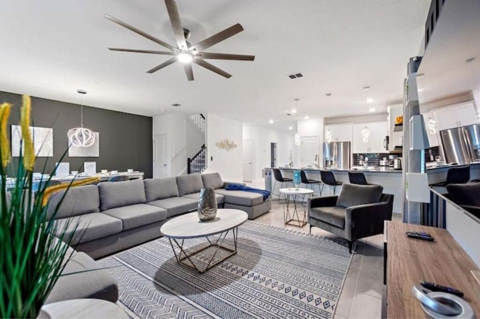 Living Room Area With TV, Kitchen & Dining Area In The Background