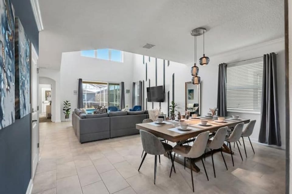 Dining Area That Seats 10 People With Living Room In Background