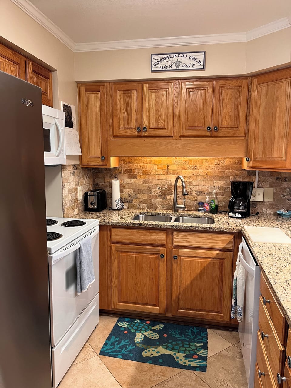 Kitchen has toaster, microwave, dishwasher, coffee maker