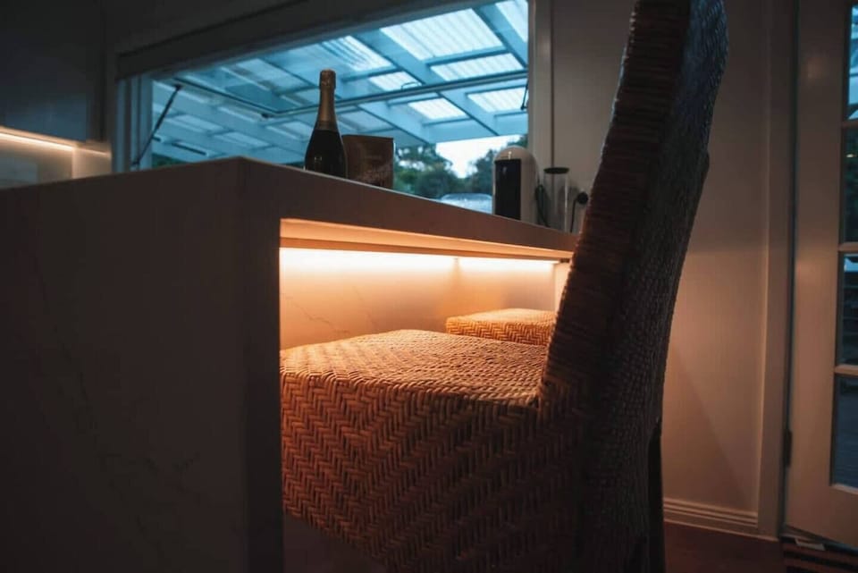 Kitchen | Pristine white stone benchtop illuminated by elegant LED ambient lighting
