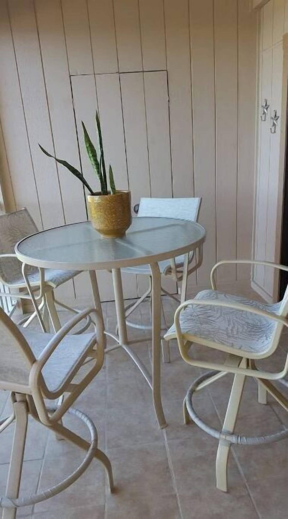 Outdoor tables with four chairs. Large container with ocean and pool stuff.