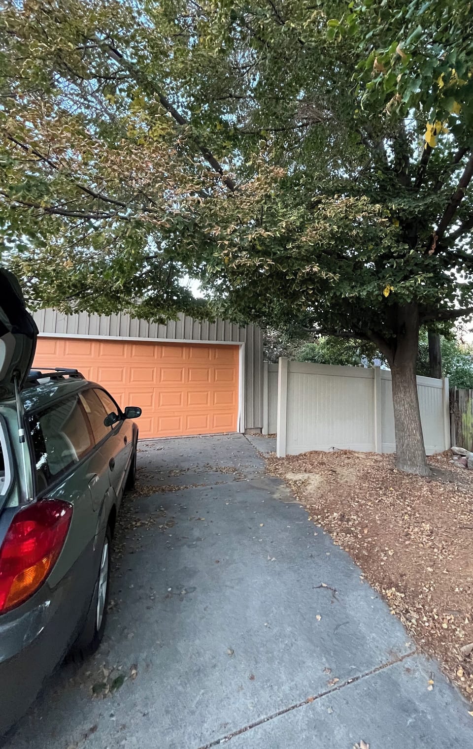 Private driveway parking with detached garage and shady tree-lined setting