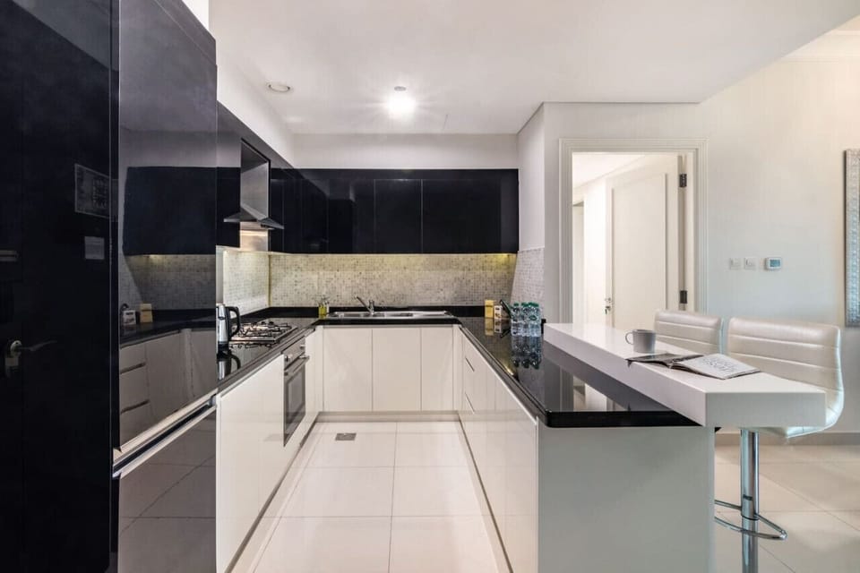 Modern Kitchen: Sleek black cabinetry and bar seating invite culinary adventures and entertaining!