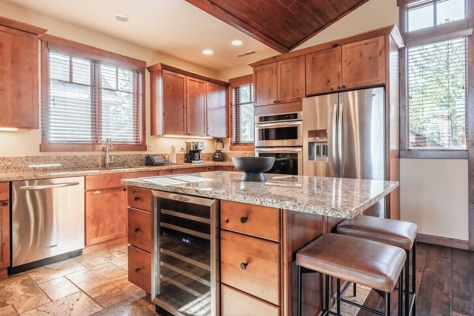 Large center island, wine fridge, bar seating.