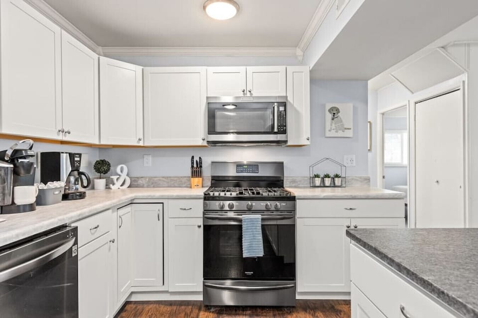 Well-appointed and modern kitchen with island, fridge, freezer, dishwasher, Keurig, drip coffee maker, stove, ample storage space and more!