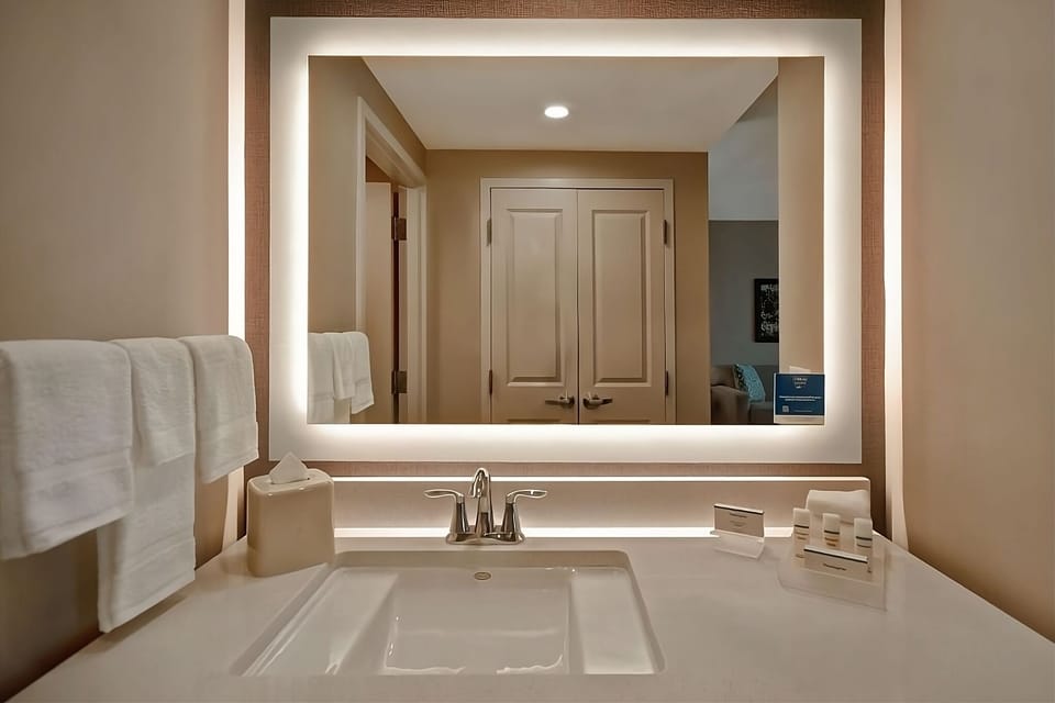 Refresh at a glowing vanity with ample counter space.