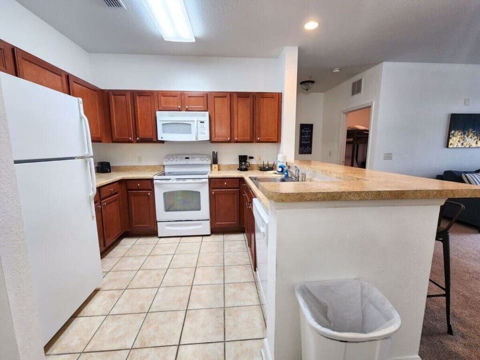 - Fully equipped kitchen - includes modern appliances and breakfast bar ideal for family meals near Orlando