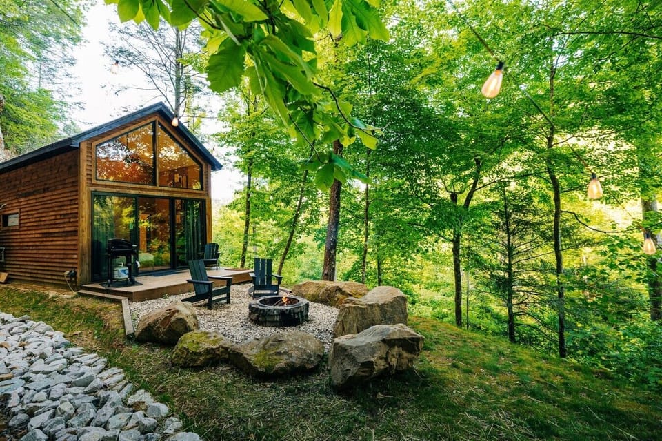 Share morning coffee on the private deck, then unwind by the fire pit in this peaceful forest retreat.