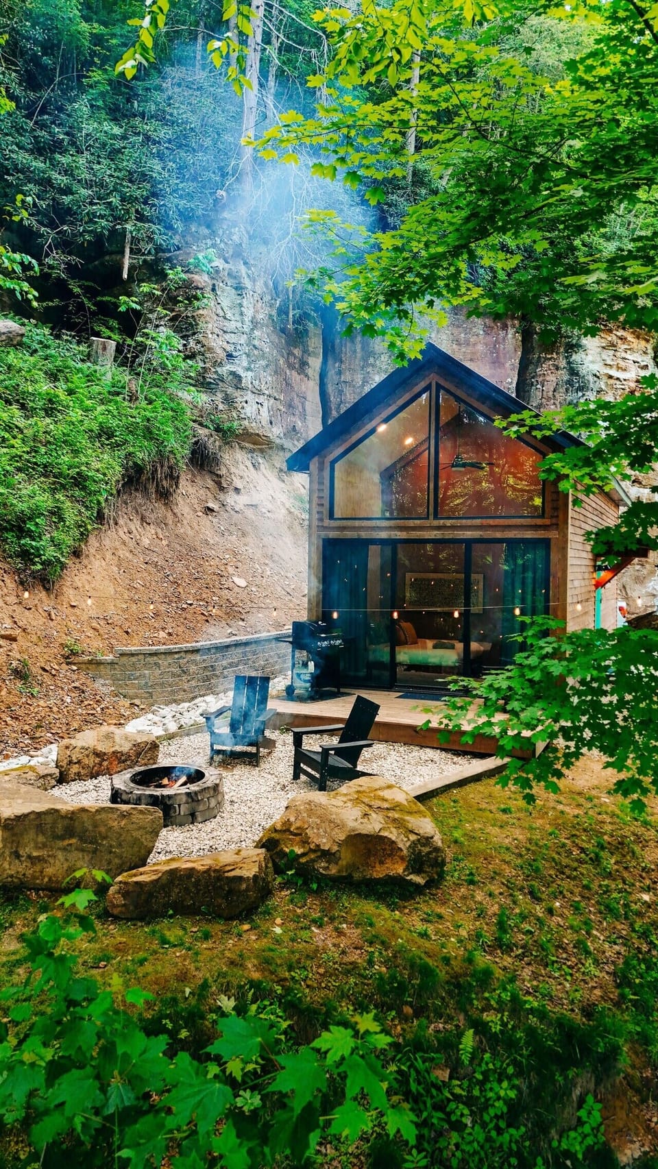 Imagine ending your mountain escape beside the fire pit, surrounded by towering cliffs, glowing windows, and forest stillness.