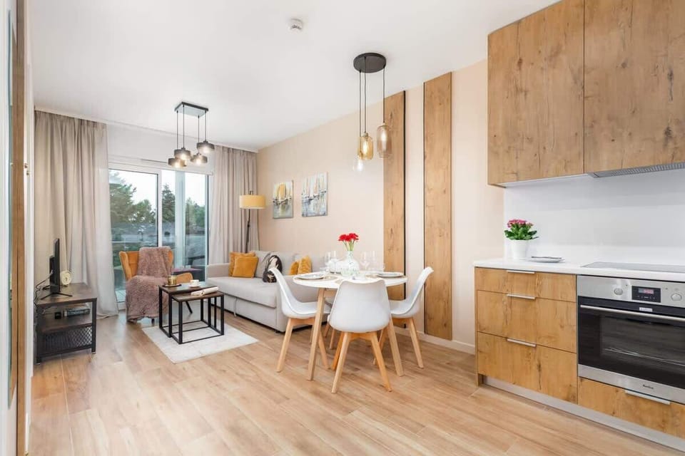 A modern kitchen with light wood finishes, ample counter space, and high-quality appliances.
