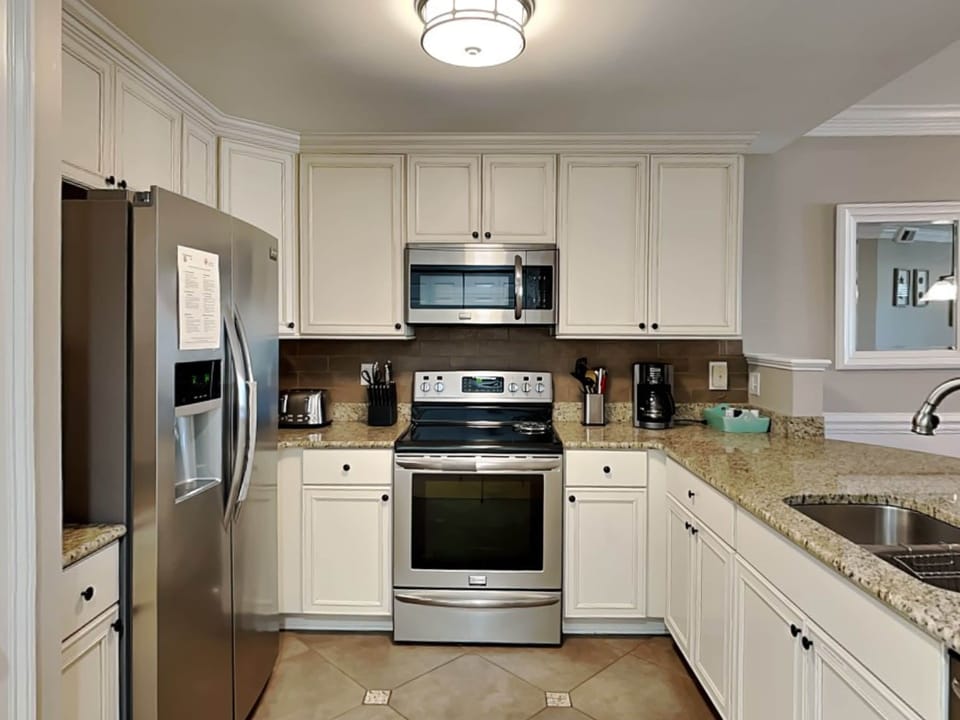 The fully-equipped kitchen with stainless appliances