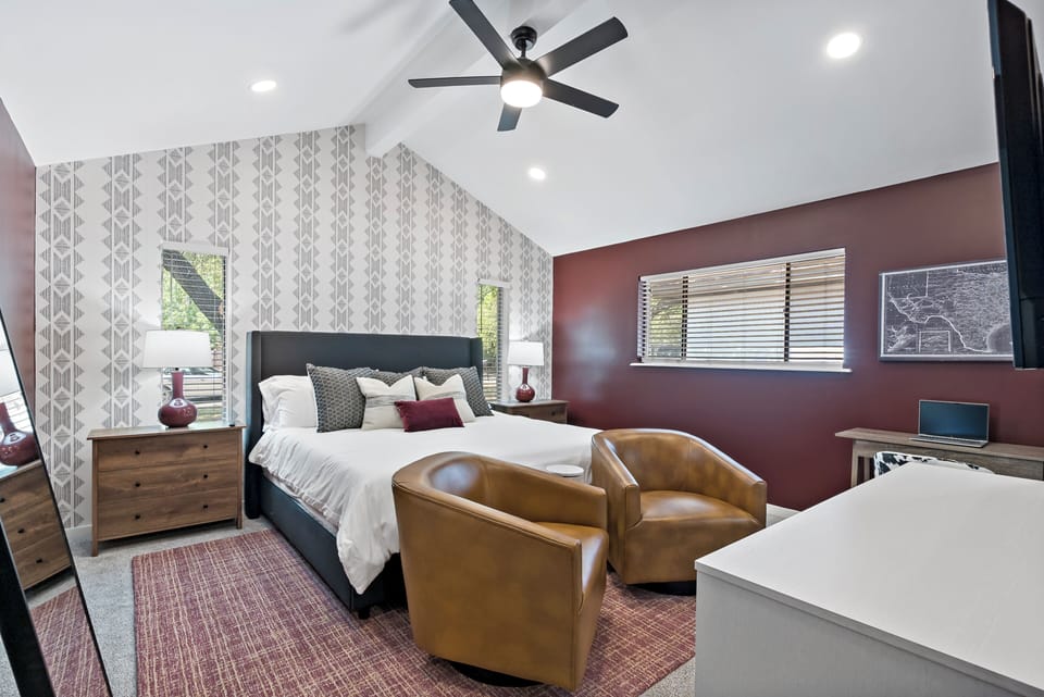 Main Bedroom: Elegant decor meets comfort with plush king bed and sitting area!