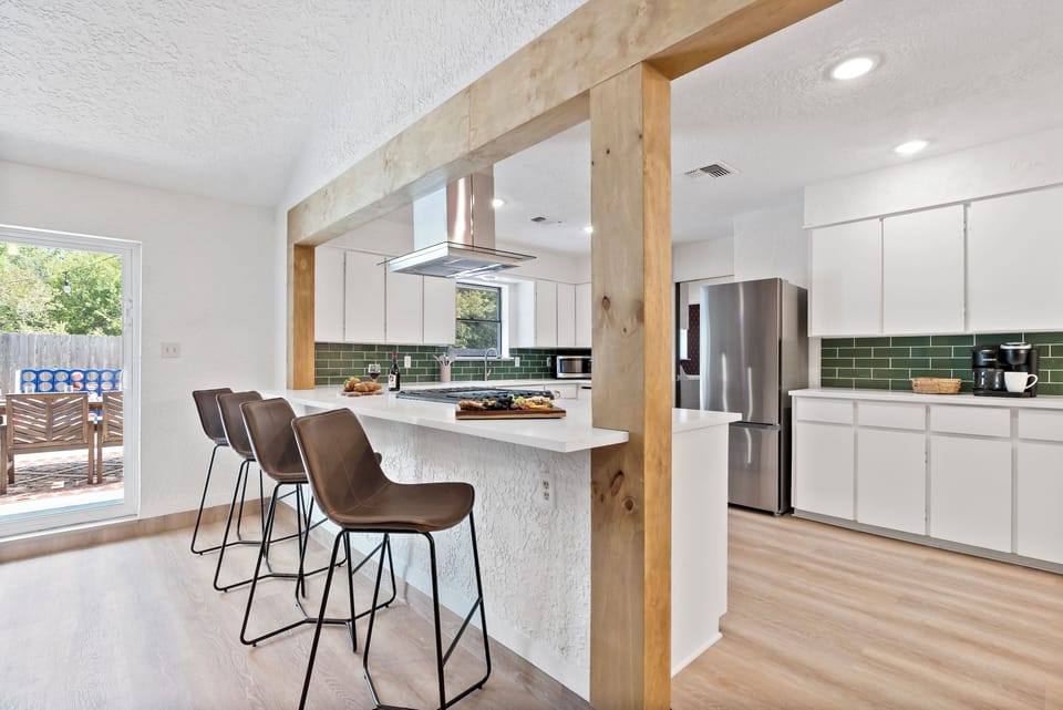 Kitchen: bright and festive with modern touches and a seamless flow to the patio