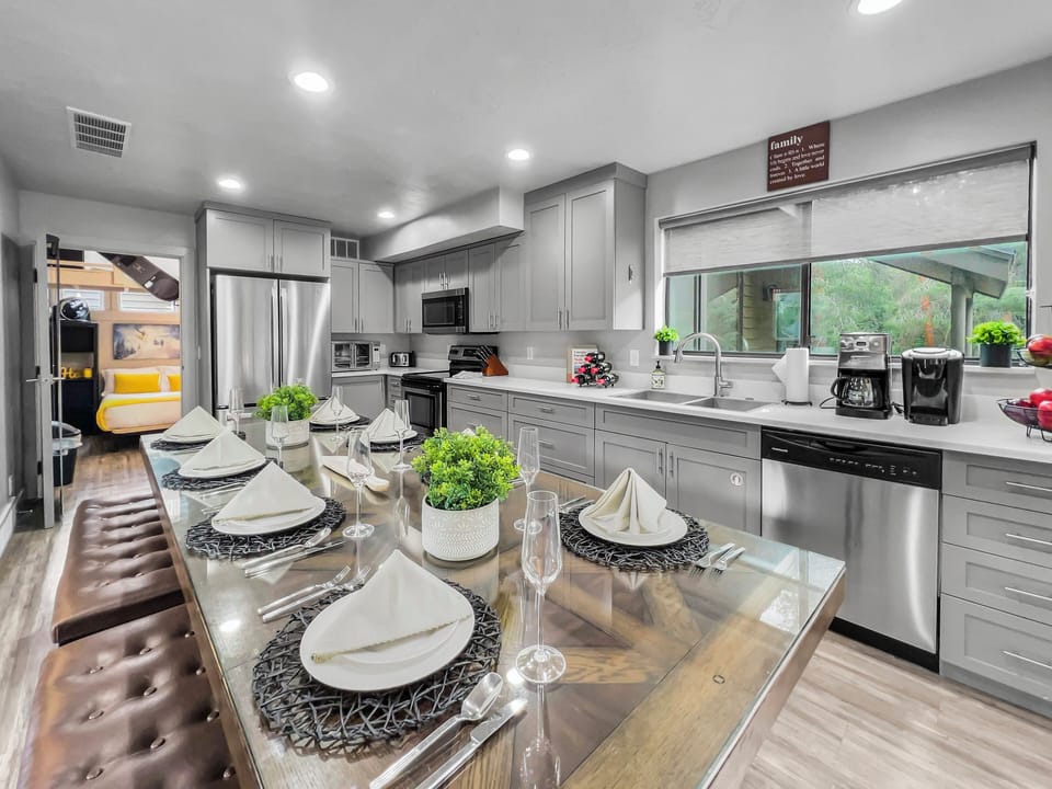 This bright, open-concept kitchen and dining area offers premium appliances and ample seating. A stylish and functional space designed for gathering, cooking, and making memories together.