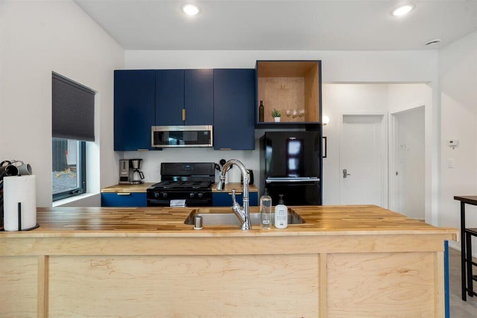 Beautiful wood counters and modern kitchen, fully stocked for enjoying a meal in should you wish to enjoy a meal in. 