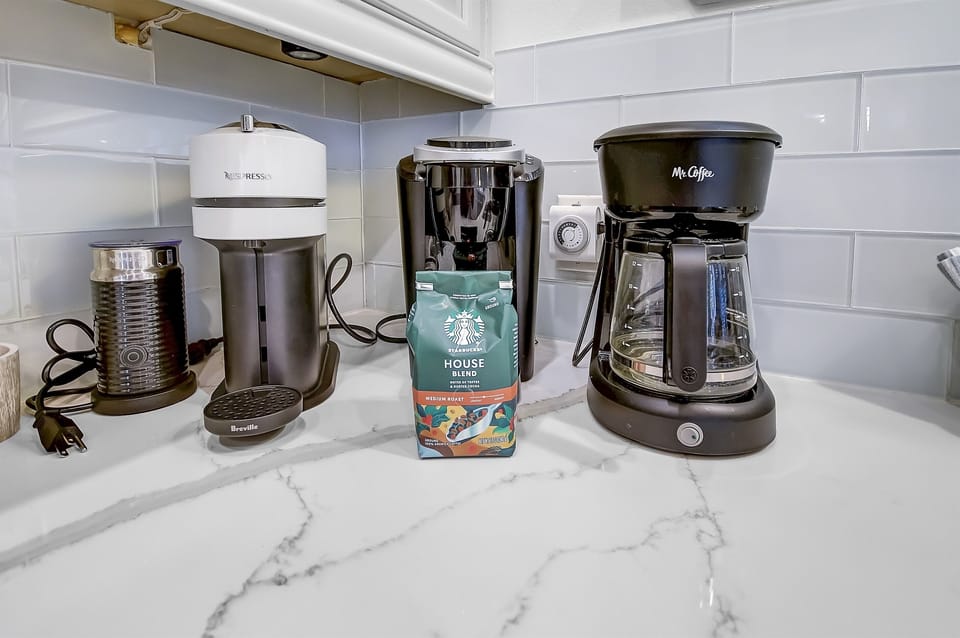 Coffee Bar - This house is equipped with a Keurig coffee maker, regular coffee pot, Nespresso machine and coffee ensuring you have access to your favorite brews with a selection of coffee pods available.