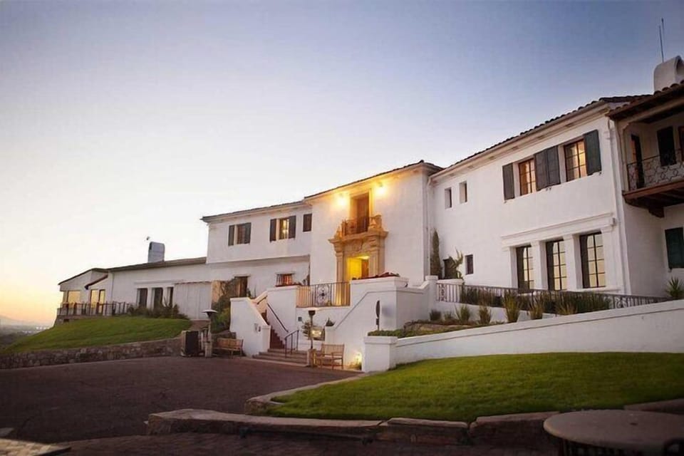 Arrive at a welcoming exterior glowing beautifully at sunset.