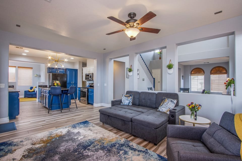Living room area with sofa bed, chaise lounge chair, and 75" UHD 4k TV