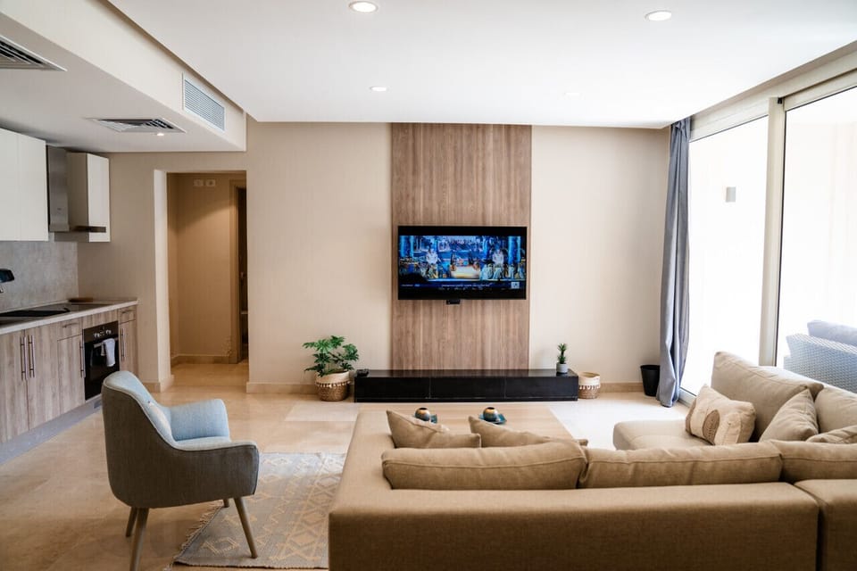 Cozy living room with a couch and a stylish coffee table and television