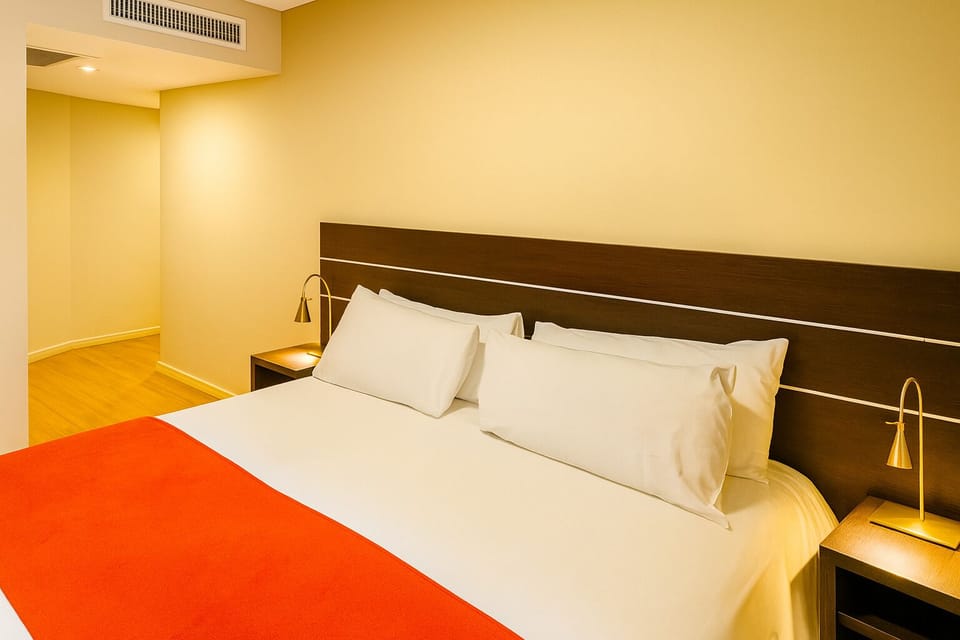 Relax in fresh, hotel-style bedding with bedside reading lamps.