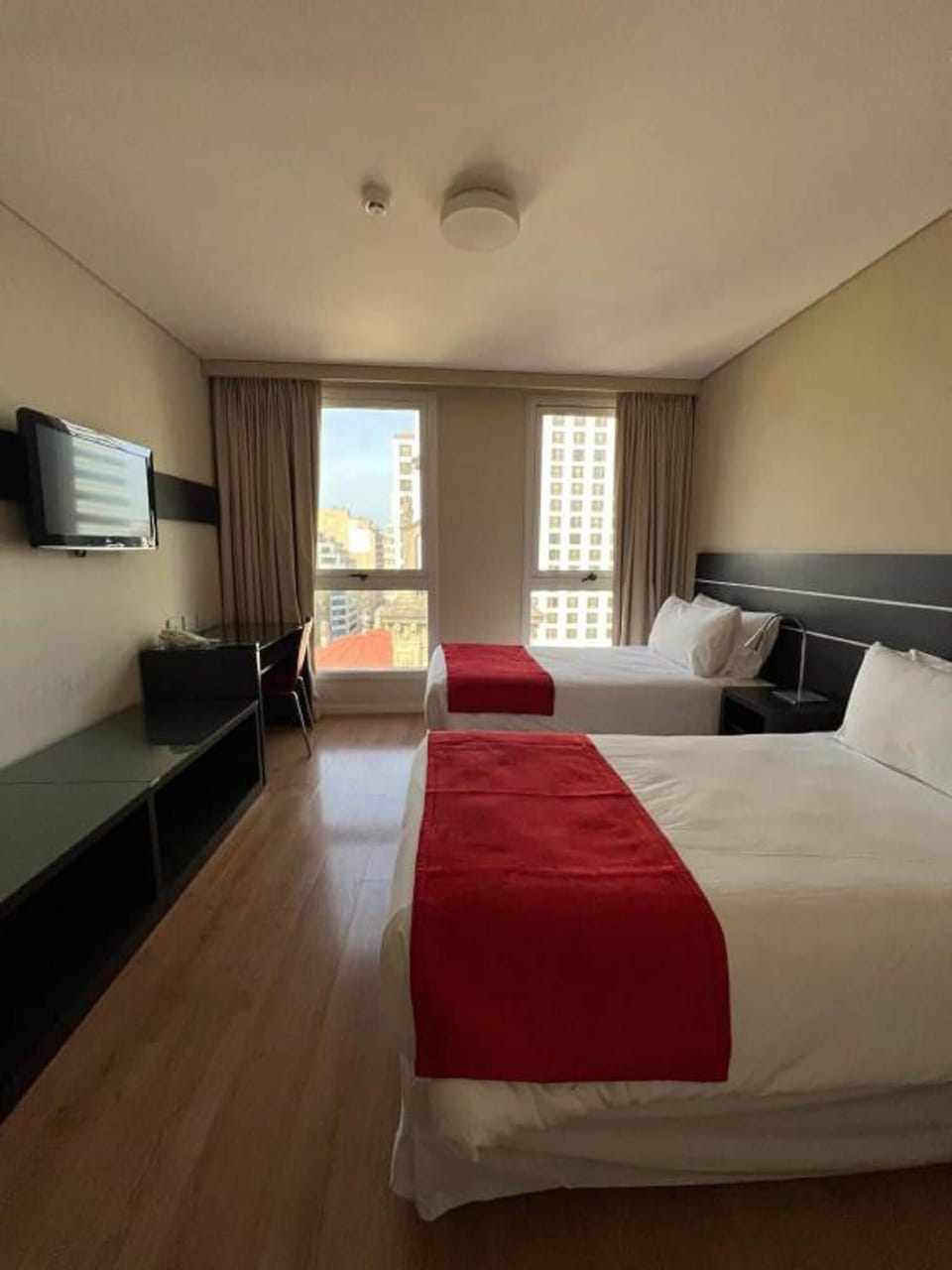 Wake up to city views from a calm, airy room.