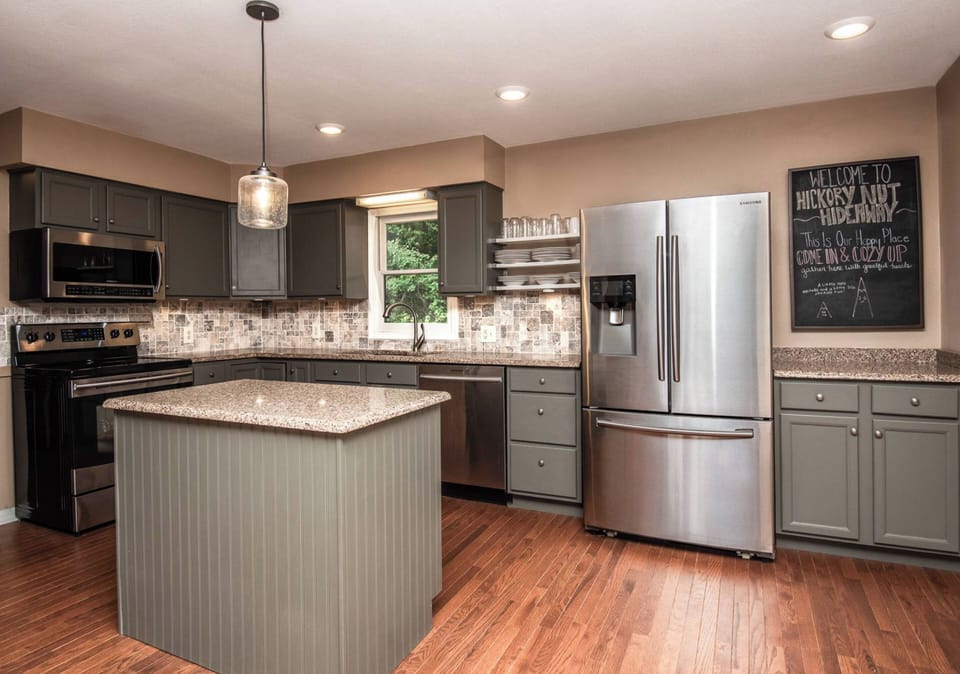 Fully-equipped kitchen with a beautiful backsplash and modern appliances.